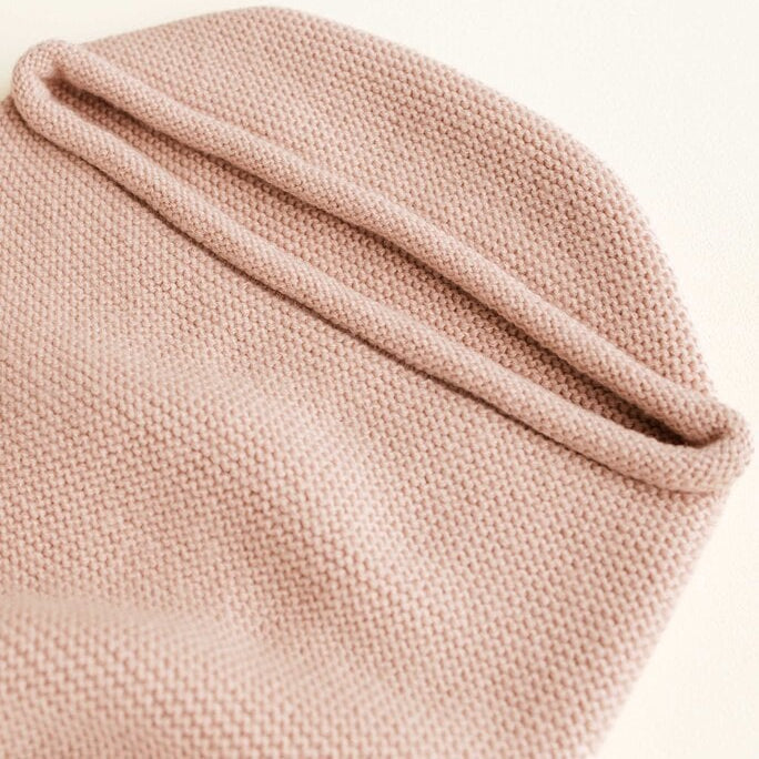 Een licht roze baby cocoon deken