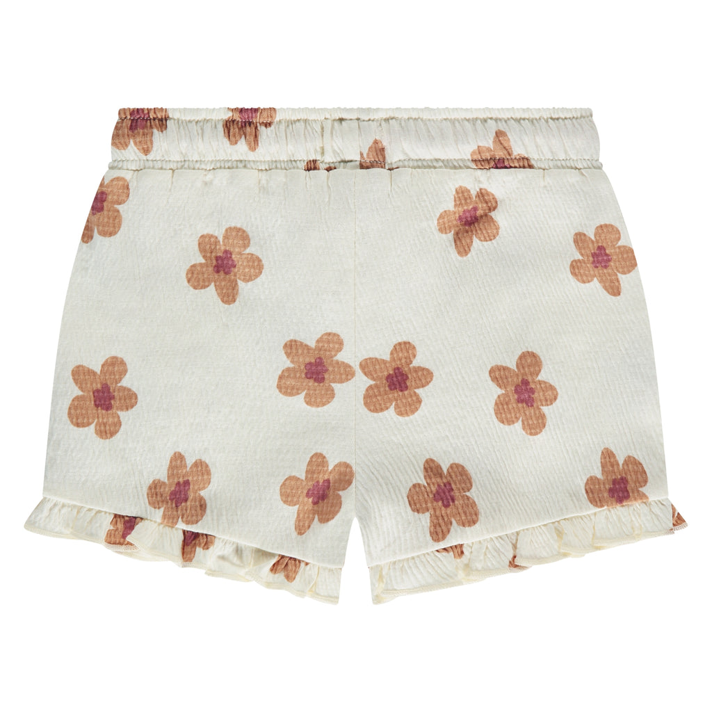 De achterkant van een witte korte broek met beige bloemetjes