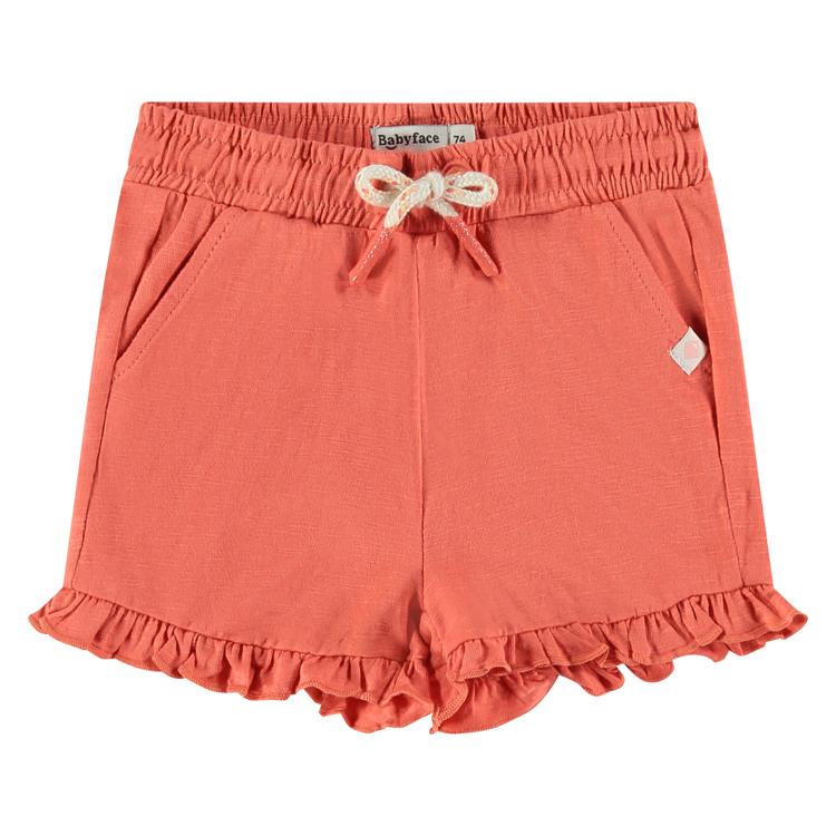 Een oranje rode baby korte broek